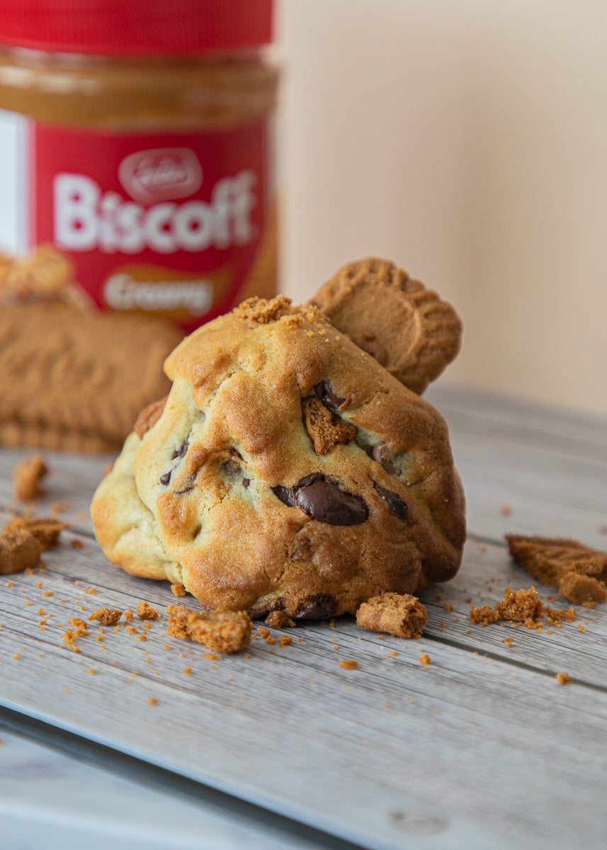 Cookie with Biscoff spread on a wooden surface